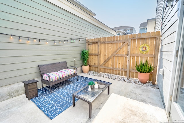 view of patio with a gate and fence