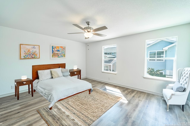 bedroom featuring light hardwood / wood-style floors and ceiling fan