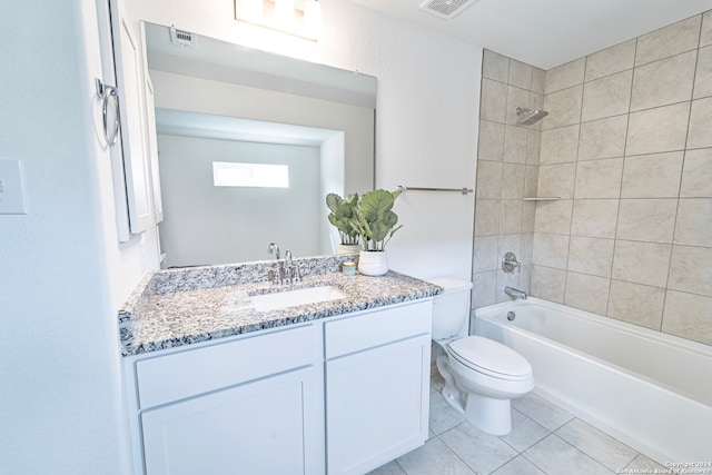 full bathroom featuring tile patterned flooring, vanity, toilet, and tiled shower / bath