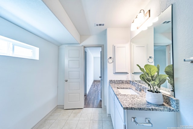 bathroom with tile patterned flooring and vanity