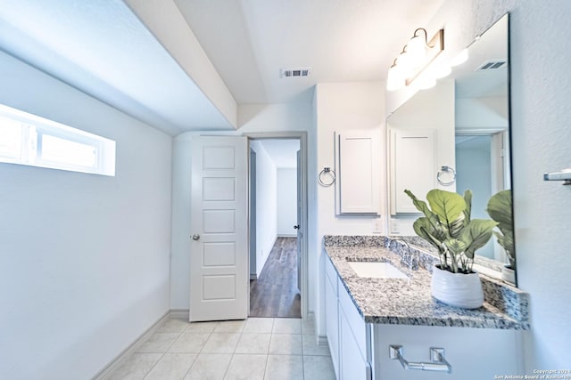 bathroom featuring tile patterned floors, baseboards, visible vents, and vanity