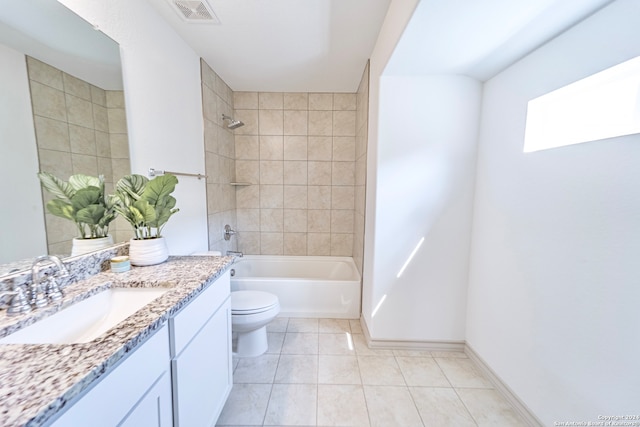 full bathroom featuring vanity, tile patterned floors, tiled shower / bath combo, and toilet