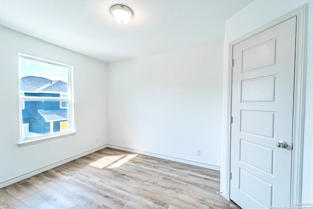 empty room with light hardwood / wood-style flooring