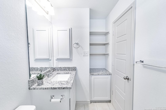 bathroom featuring tile patterned flooring and vanity