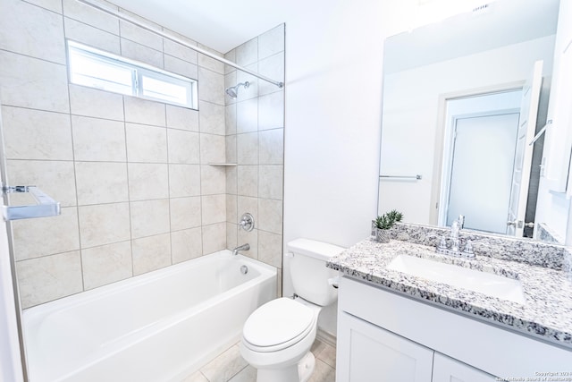 full bathroom with tile patterned flooring, vanity, toilet, and tiled shower / bath combo