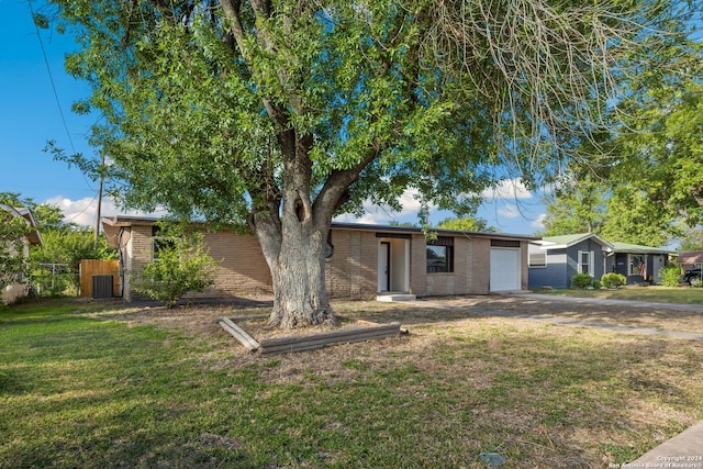 single story home with a front lawn and a garage