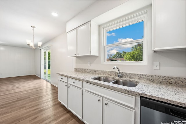 kitchen featuring hardwood / wood-style floors, sink, light stone countertops, stainless steel dishwasher, and white cabinets