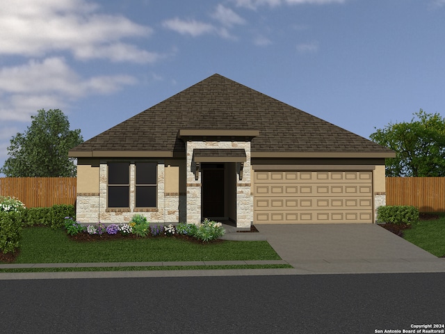 view of front of home featuring a garage and a front yard