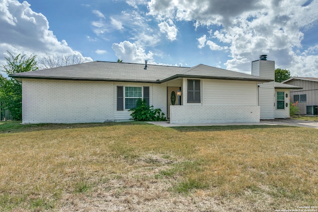 ranch-style home with central AC unit and a front lawn