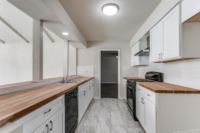 kitchen featuring butcher block countertops, tasteful backsplash, white cabinets, sink, and black appliances