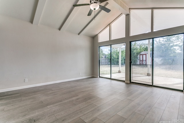 spare room with ceiling fan, beam ceiling, high vaulted ceiling, and wood-type flooring