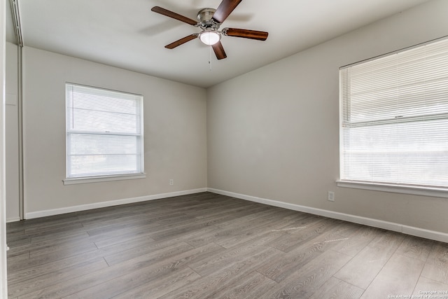 spare room with ceiling fan and wood-type flooring