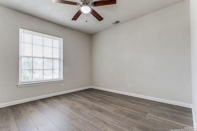 empty room with hardwood / wood-style floors and ceiling fan