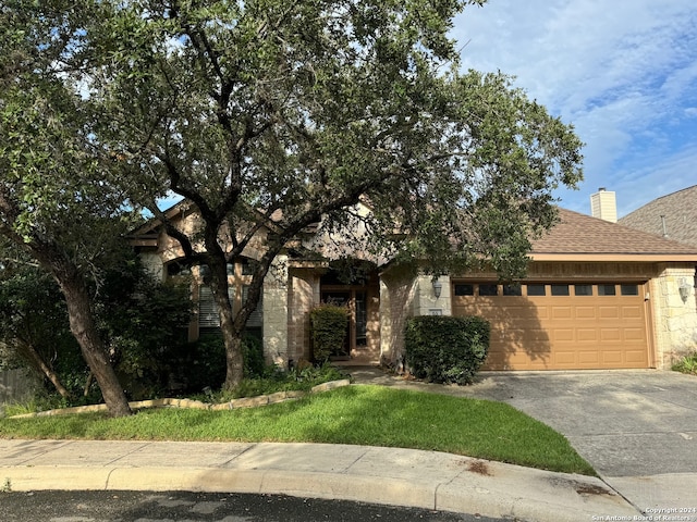 obstructed view of property with a garage