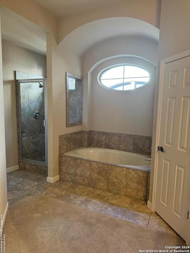 bathroom with tile patterned flooring and separate shower and tub