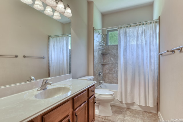 full bathroom featuring tile patterned flooring, shower / bath combination with curtain, vanity, and toilet