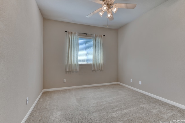 carpeted spare room with ceiling fan