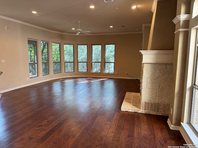 unfurnished living room featuring ceiling fan, dark hardwood / wood-style floors, a healthy amount of sunlight, and ornamental molding