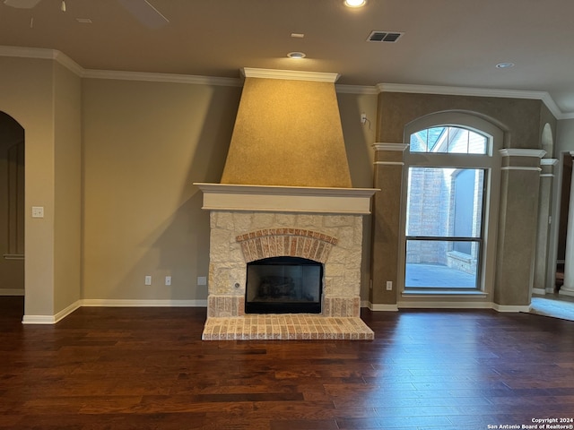 unfurnished living room featuring ceiling fan, hardwood / wood-style flooring, crown molding, and a brick fireplace