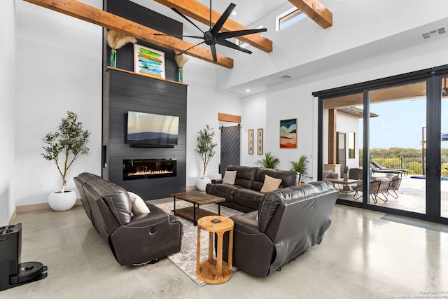 living room with beam ceiling, finished concrete flooring, visible vents, and a large fireplace