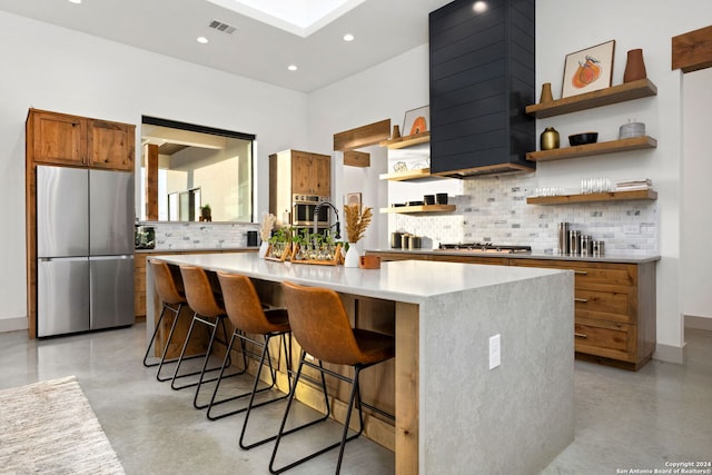 kitchen featuring open shelves, finished concrete flooring, light countertops, and stainless steel appliances