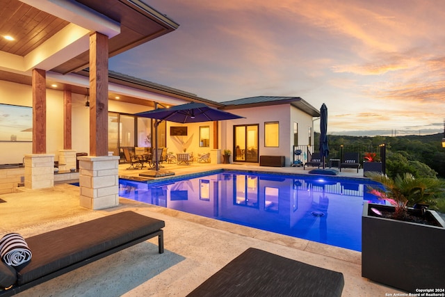 view of swimming pool featuring a fenced in pool, fence, and a patio area