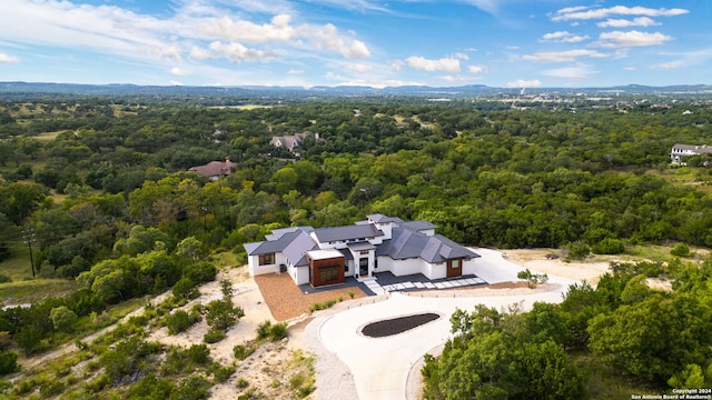 drone / aerial view featuring a forest view