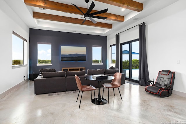 living area with beamed ceiling, visible vents, concrete floors, and baseboards