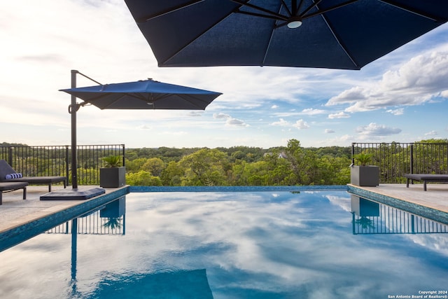 view of swimming pool with a fenced in pool, a patio, and fence