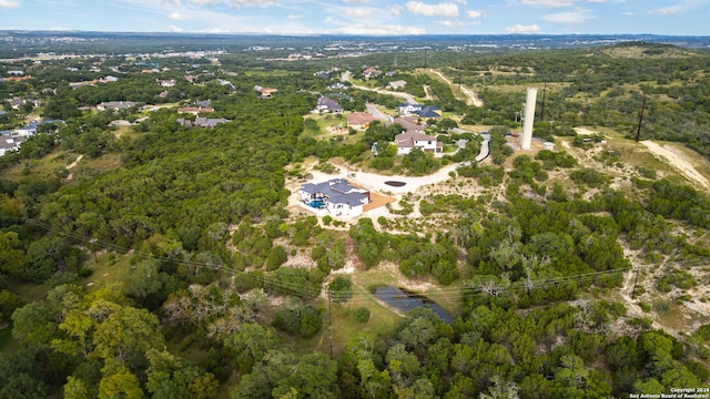 birds eye view of property with a forest view