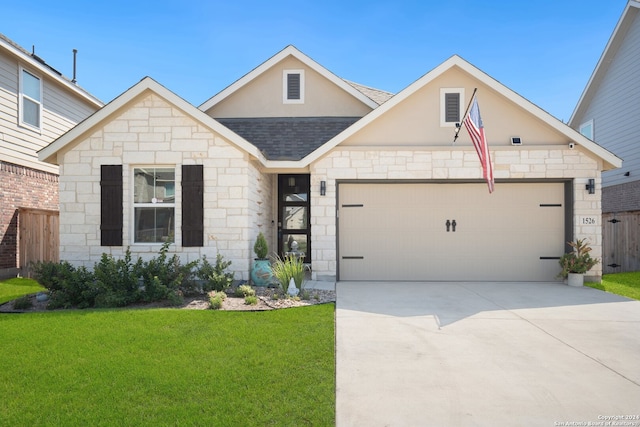 view of front facade featuring a front lawn and a garage