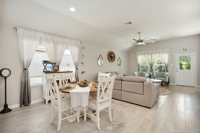 dining space featuring ceiling fan, light hardwood / wood-style floors, and lofted ceiling