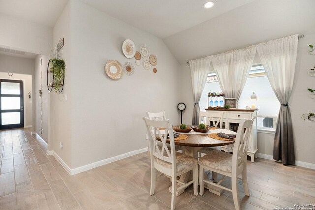 dining space with vaulted ceiling