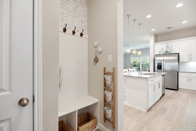 mudroom with light tile patterned floors and sink