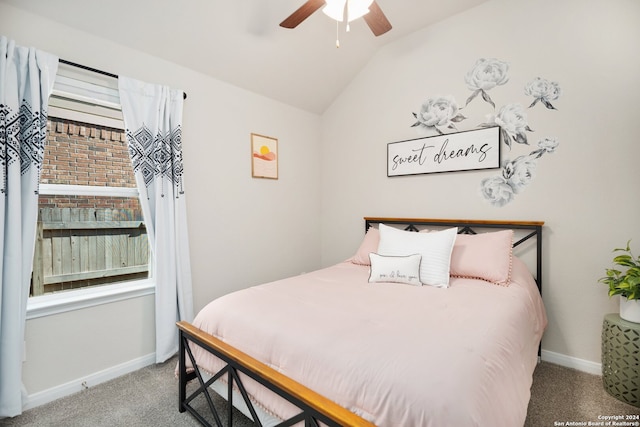 carpeted bedroom featuring ceiling fan and vaulted ceiling