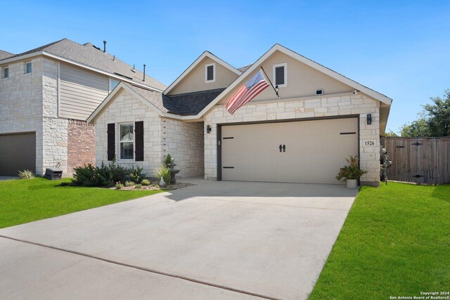 view of front of house featuring a front lawn and a garage