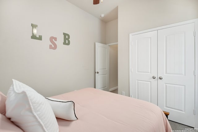 bedroom with ceiling fan, carpet, and a closet