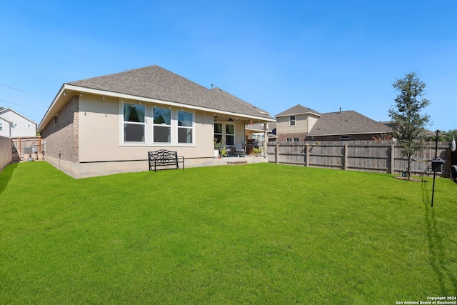 rear view of house with a patio area and a yard