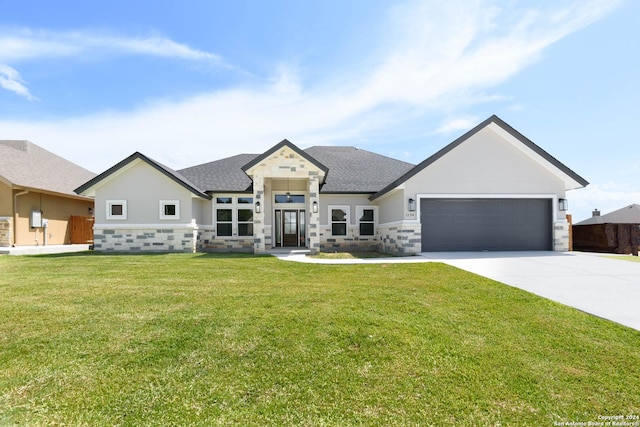 view of front facade with a garage, stone siding, a front lawn, and concrete driveway