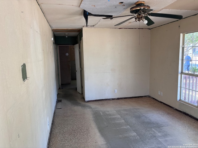 tiled empty room with ceiling fan