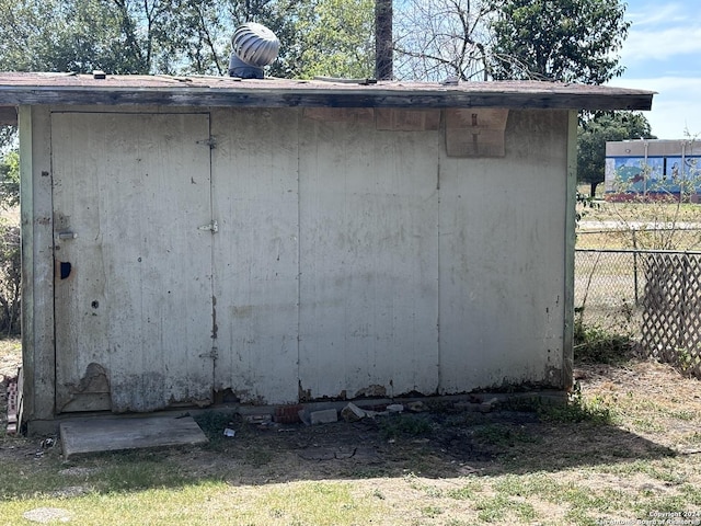 view of shed featuring fence