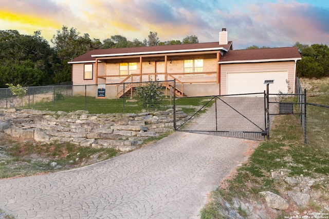 view of front of home with covered porch and a garage