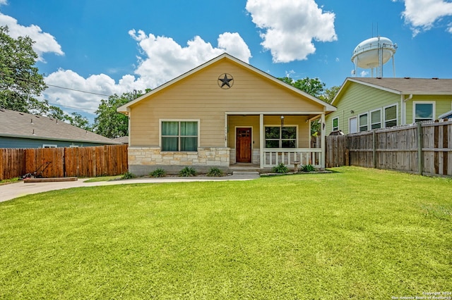 view of front of house with covered porch and a front lawn