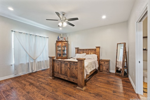 bedroom featuring ceiling fan, dark wood-type flooring, and ensuite bathroom