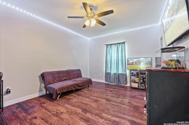 living area with ceiling fan and wood-type flooring