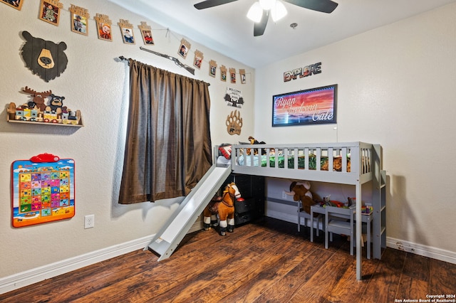 bedroom with dark hardwood / wood-style flooring and ceiling fan