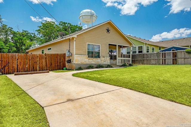 view of front facade with a patio and a front yard