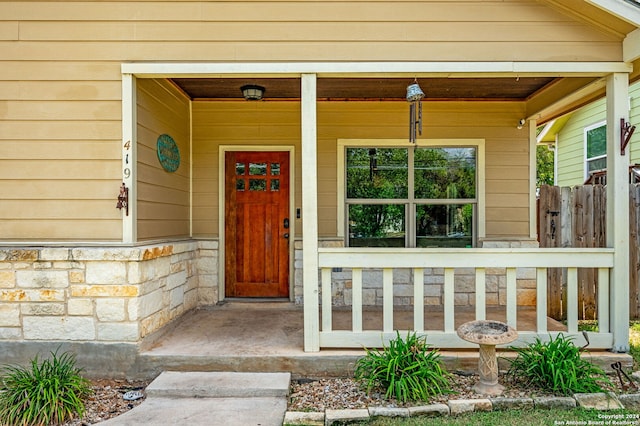 view of exterior entry featuring a porch