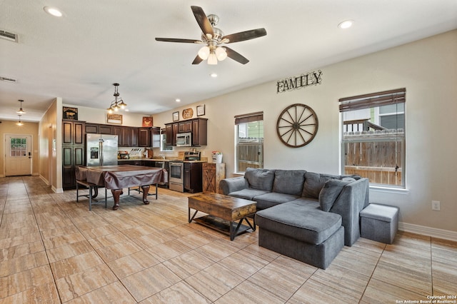 living room with ceiling fan and light tile patterned floors