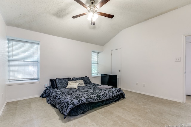 bedroom with ceiling fan, a textured ceiling, and lofted ceiling